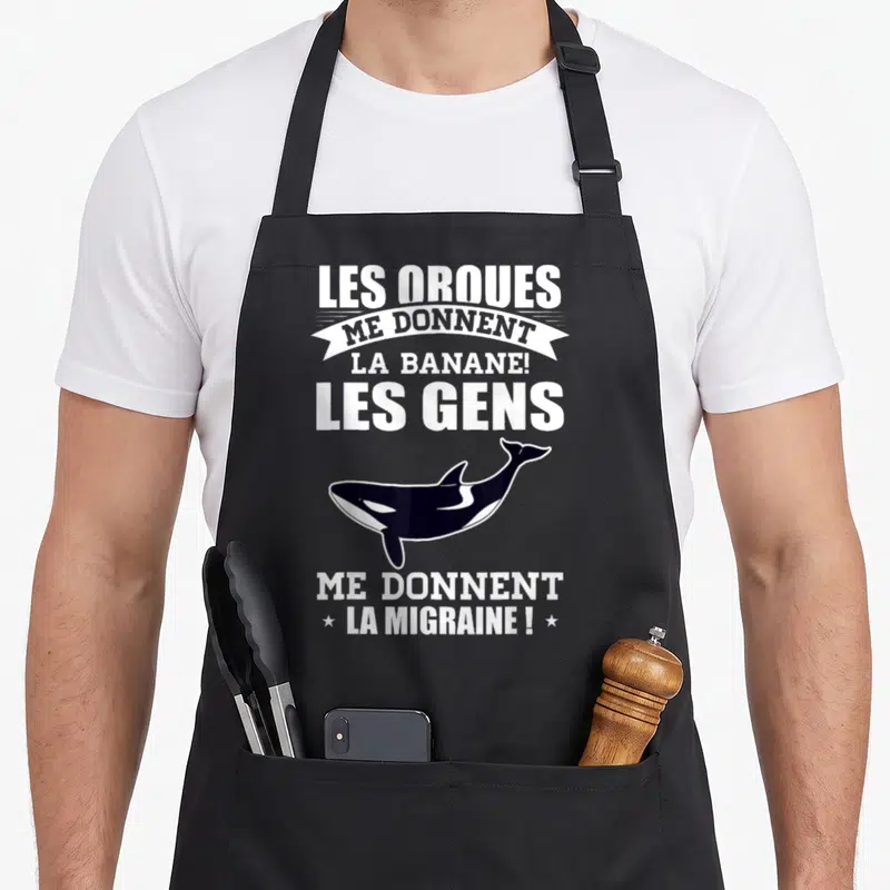 Tablier de cuisine noir avec illustration d'orque et texte blanc Les orques me donnent la banane les gens me donnent la migraine