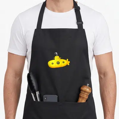 Tablier de cuisine noir avec un sous-marin jaune mignon imprimé au centre du torse.