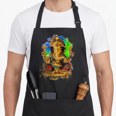 Tablier de cuisine noir avec une illustration colorée du Seigneur Ganesha aux éclats de peinture bleue et verte.