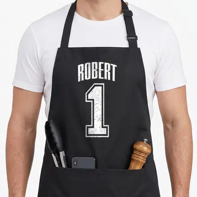Tablier de cuisine noir avec l'inscription ROBERT et le chiffre 1 en blanc style maillot sportif dégradé.