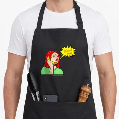 Tablier de cuisine noir avec illustration d'une femme aux cheveux rouges pleurant en tenant un banana comme téléphone et le texte Y'a pas wesh.