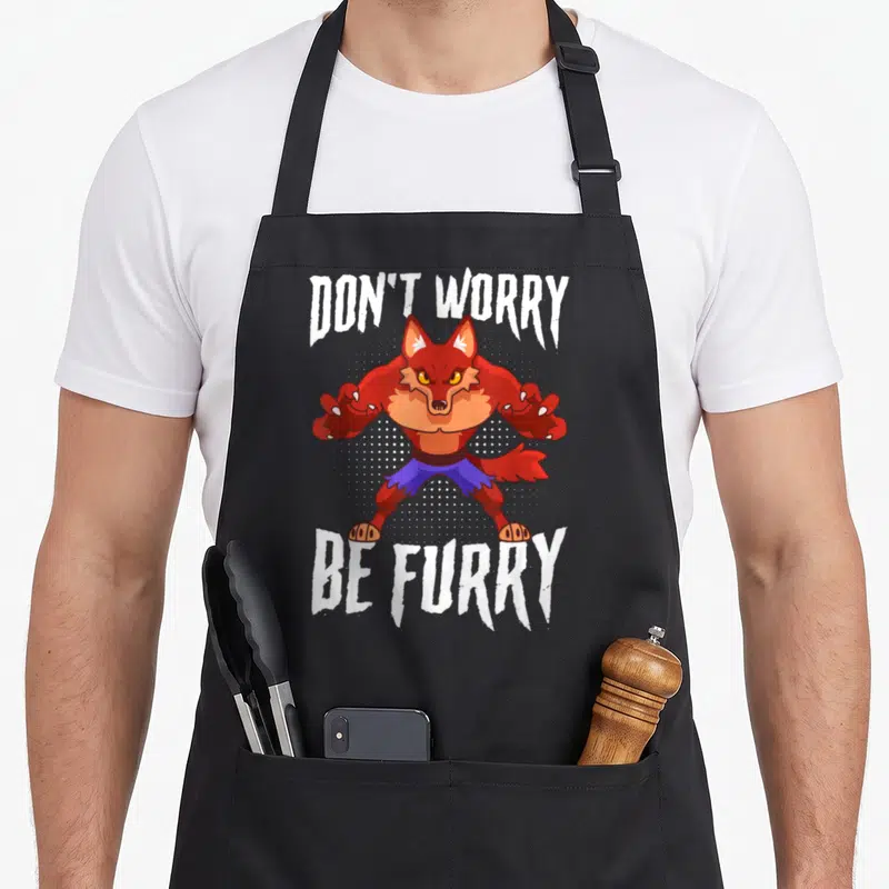 Tablier de cuisine noir avec illustration d'un loup anthropomorphe rouge et du texte DON'T WORRY BE FURRY en blanc.