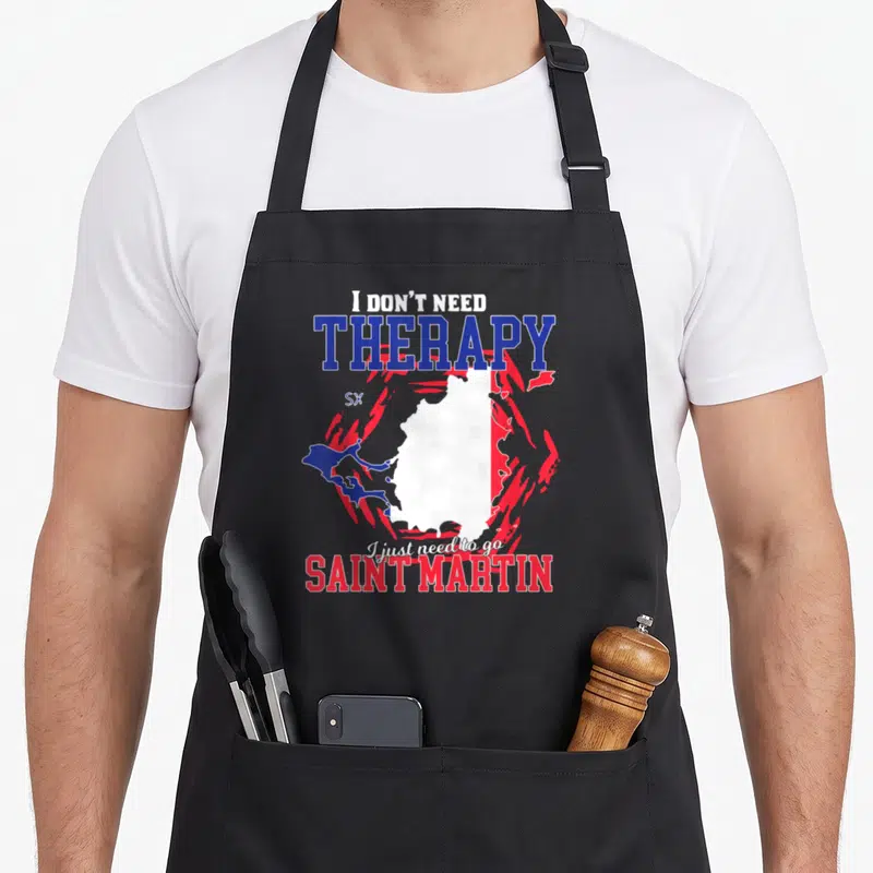 Tablier de cuisine noir avec une carte de Saint Martin et le texte I don't need therapy en lettres bleues et rouges.