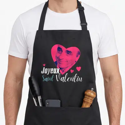 Tablier de cuisine noir avec portrait d'Eric Zemmour dans un cœur rose et l'inscription Joyeux Saint Valentin.