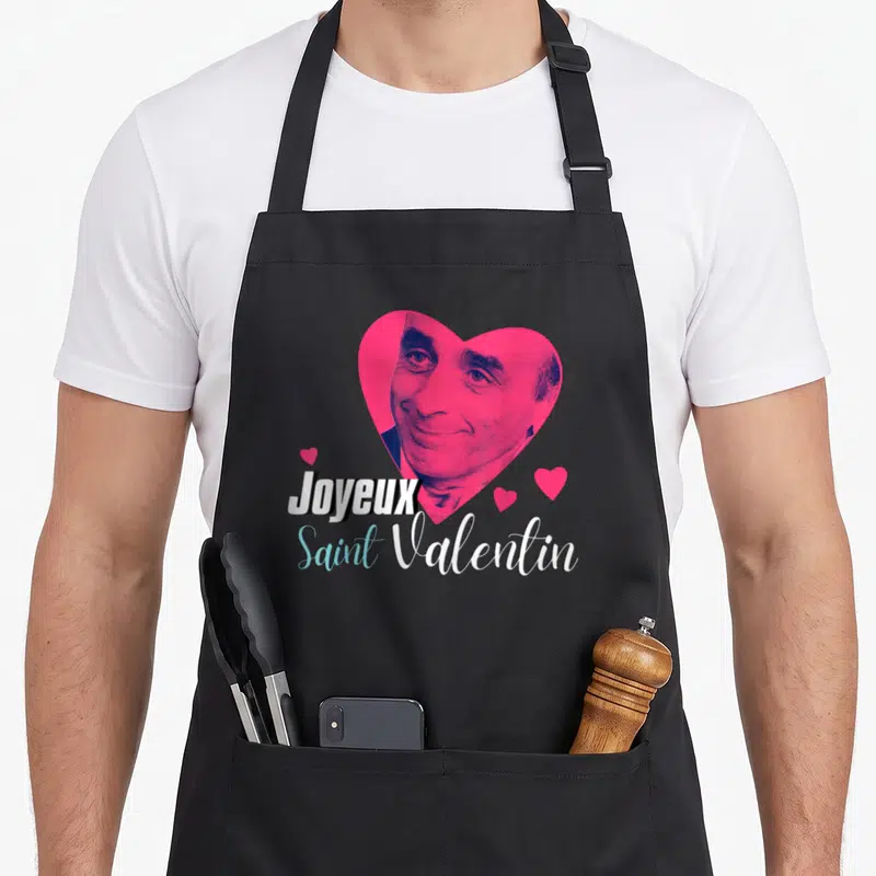 Tablier de cuisine noir avec portrait d'Eric Zemmour dans un cœur rose et l'inscription Joyeux Saint Valentin.