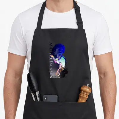 Tablier de cuisine noir avec illustration verticale de Michael Jackson et son nom en lettres blanches.