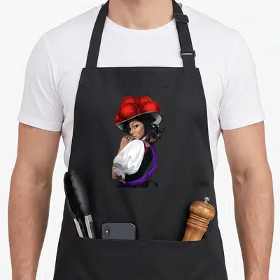 Tablier de cuisine noir avec illustration d'une femme au grand chapeau rouge et tenues traditionnelles colorées.