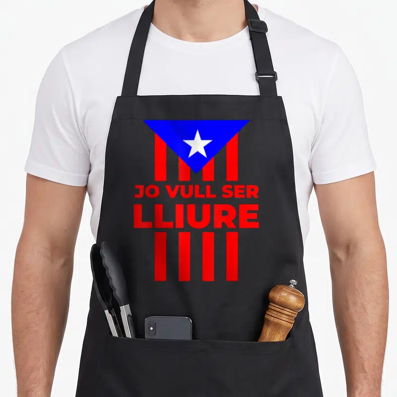 Tablier de cuisine noir avec le drapeau estelada et le texte Jo Vull Ser Lliure en rouge.