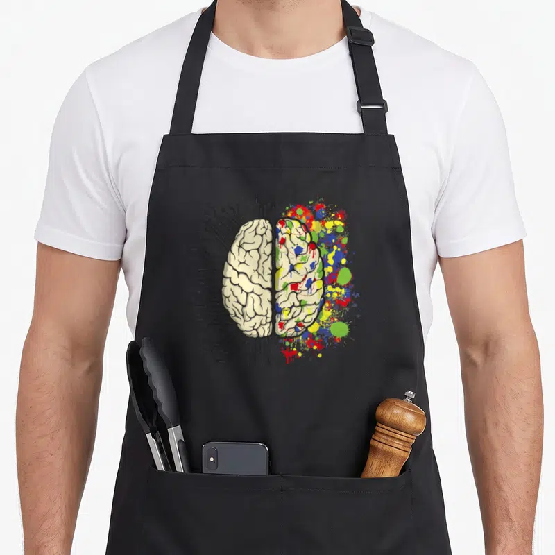 Tablier de cuisine noir avec illustration cerveau moitié circuit électronique moitié taches de peinture multicolores