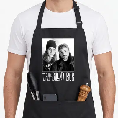 Tablier de cuisine noir avec portrait noir et blanc de Jay et Silent Bob et leur nom imprimé en bas.