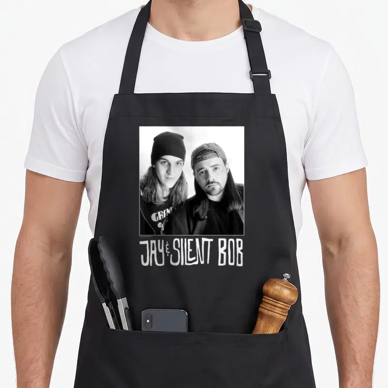 Tablier de cuisine noir avec portrait noir et blanc de Jay et Silent Bob et leur nom imprimé en bas.