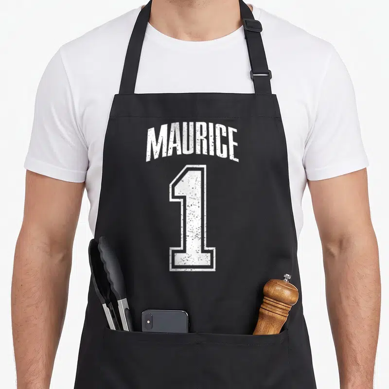 Tablier de cuisine noir avec inscription blanche Maurice et grand chiffre 1 style maillot de sport délavé.