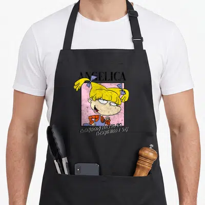 Tablier de cuisine noir avec le personnage Angelica et la phrase Everybody Has To Do Everything I Say imprimés en couleur.