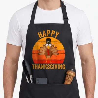 Tablier de cuisine noir avec un dindon en chapeau haut de forme et texte Happy Thanksgiving Day.