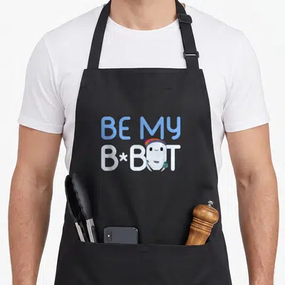 Tablier de cuisine noir avec un robot blanc portant un bonnet et le texte Be My B-Bot en lettres bleues et blanches.
