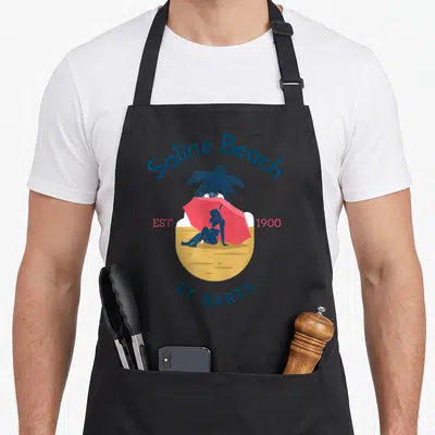 Tablier de cuisine noir avec illustration Saline Beach Saint-Barthélemy Est 1900 St. Barts