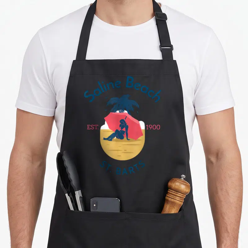 Tablier de cuisine noir avec illustration Saline Beach Saint-Barthélemy Est 1900 St. Barts