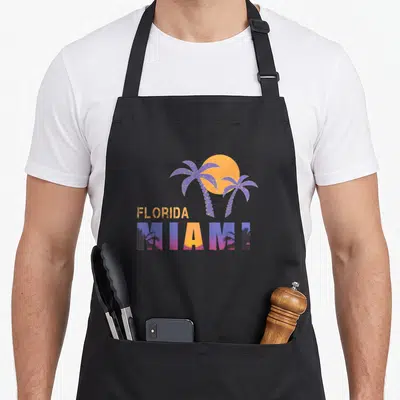 Tablier de cuisine noir avec illustration Florida Miami palmiers et soleil orange style rétro