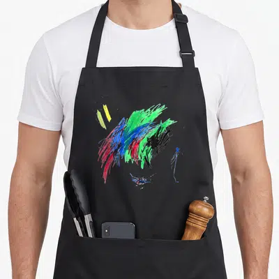 Tablier de cuisine noir avec des traits de crayons colorés abstraits en rouge, bleu, vert et jaune sur le devant.