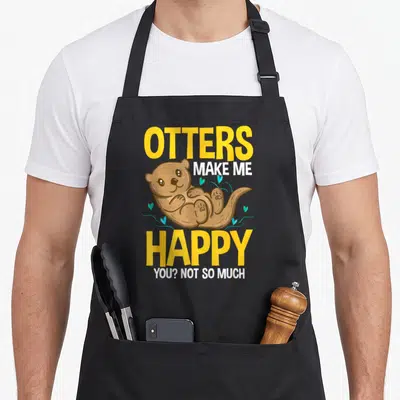 Tablier de cuisine noir avec illustration de loutre et texte Otters Make Me Happy You Not So Much en jaune et blanc.