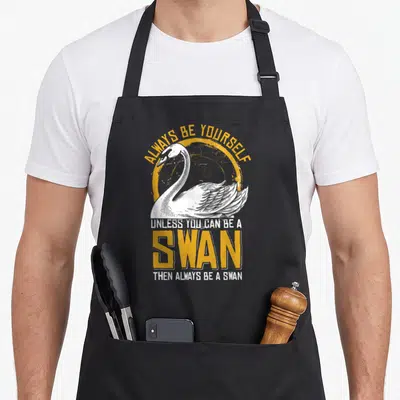 Tablier de cuisine noir avec illustration d'un cygne blanc et texte Always Be Yourself Unless You Can Be A Swan Then Always Be A Swan.