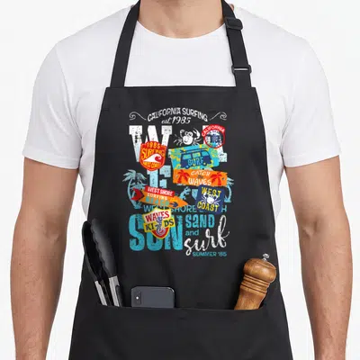 Tablier de cuisine noir avec motif graphique coloré sur le thème du surf californien et des stickers vintage.