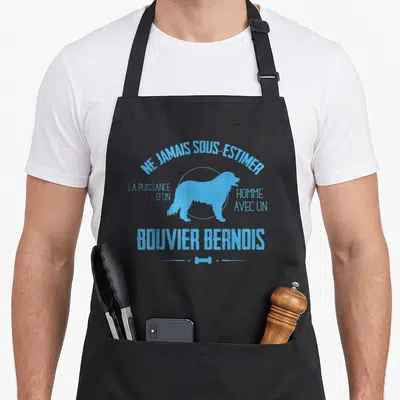 Tablier de cuisine noir avec silhouette bleue de chien et texte Ne Jamais Sous Estimer La Puissance D'un Homme Avec Un Bouvier Bernois
