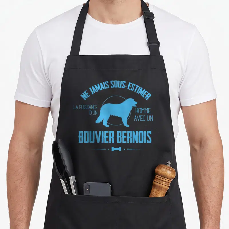 Tablier de cuisine noir avec silhouette bleue de chien et texte Ne Jamais Sous Estimer La Puissance D'un Homme Avec Un Bouvier Bernois