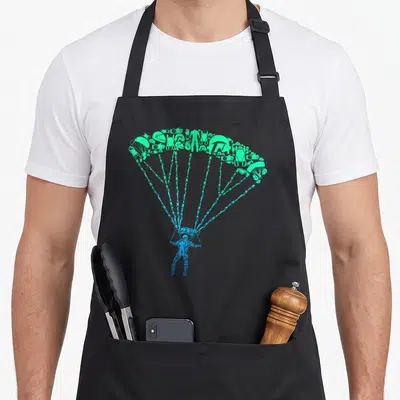 Tablier de cuisine noir avec un parachutiste bleu et une voile verte composée d'icônes d'équipement de saut.
