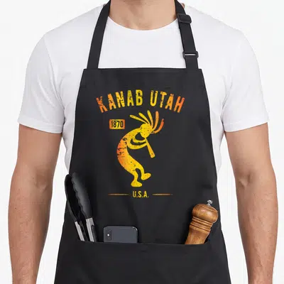 Tablier de cuisine noir avec illustration orange du Kokopelli Kanab Utah 1870 U.S.A., style vieilli et festif.