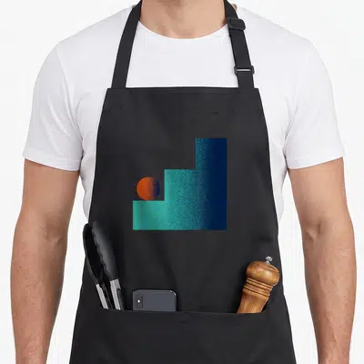 Tablier de cuisine noir avec motif d'une balle orange posée sur des escaliers turquoise texturés dans un style abstrait géométrique.