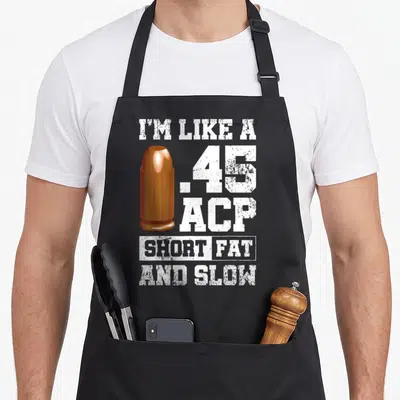 Tablier de cuisine noir avec illustration de balle orange et texte blanc 45 ACP Short Fat And Slow.