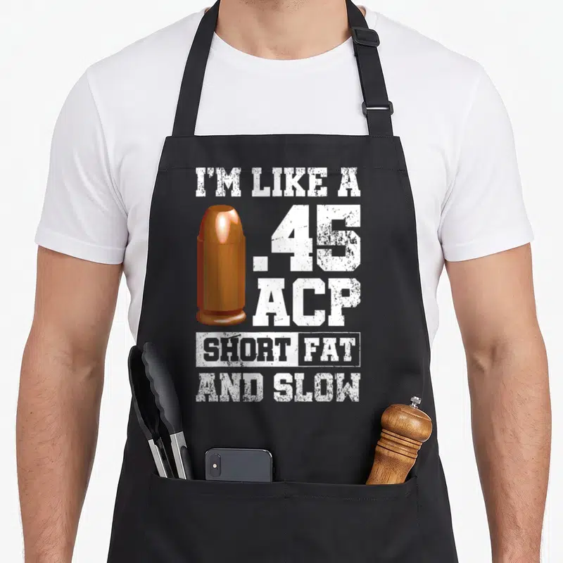 Tablier de cuisine noir avec illustration de balle orange et texte blanc 45 ACP Short Fat And Slow.