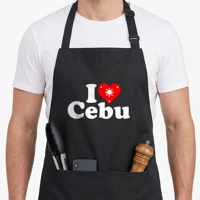 Tablier de cuisine noir avec un motif blanc et rouge représentant J'aime Cebu et un cœur stylisé.