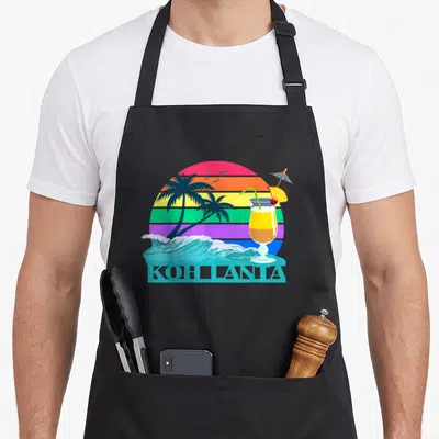 Tablier de cuisine noir avec illustration d'un cocktail tropical, palmiers et soleil arc-en-ciel sur fond turquoise.