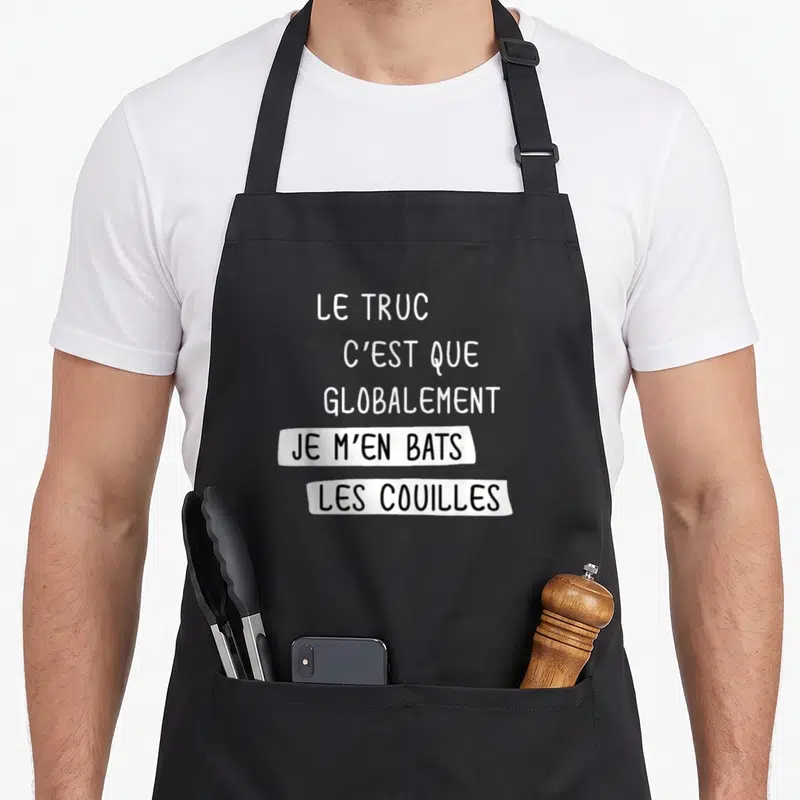 Tablier de cuisine noir avec inscription blanche et noire sur bandelette : Le truc c'est que globalement je m'en bats les couilles.