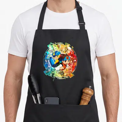 Tablier de cuisine noir avec illustration circulaire de Mega Man Battle Network et ses personnages, couleurs vives sur fond sombre.