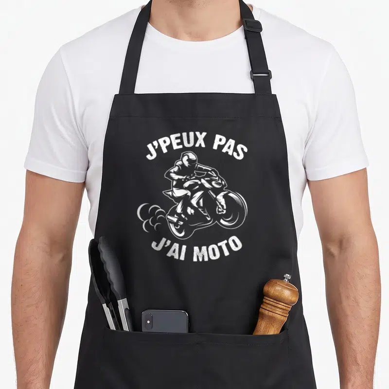 Tablier de cuisine noir avec inscription J'peux pas j'ai moto et illustration motard blanc