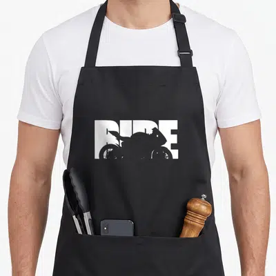 Tablier de cuisine noir avec le mot Ride en blanc et une silhouette de moto sportive intégrée au texte.