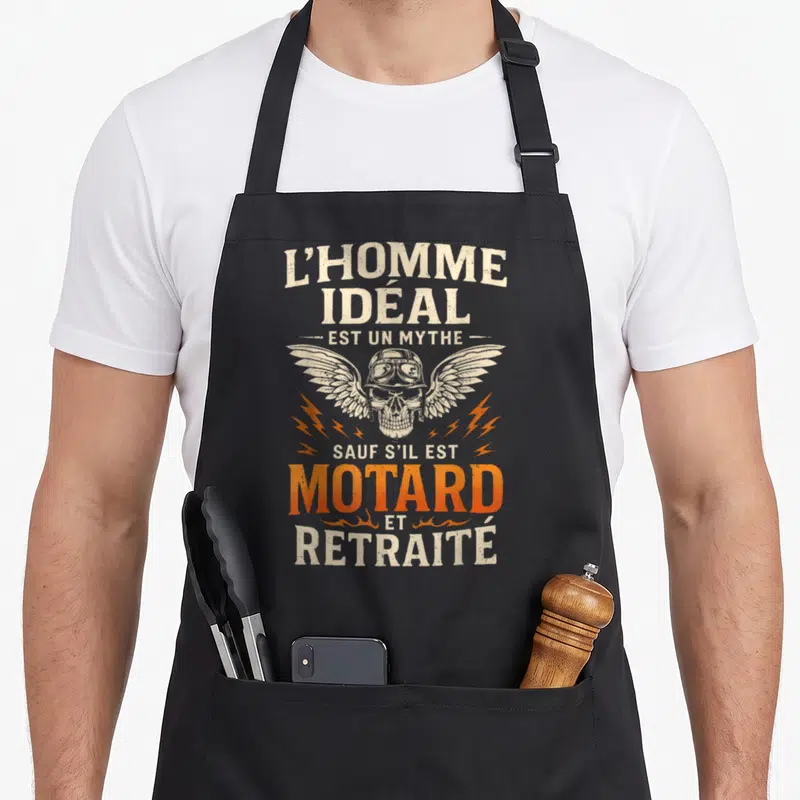 Tablier de cuisine noir avec illustration crâne aile et texte L'homme idéal est un mythe motard et retraité en orange et blanc.
