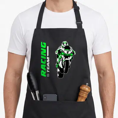 Tablier de cuisine noir avec illustration d'un cyclomoteur de course vert et blanc portant le numéro 1 et le texte Racing Team.