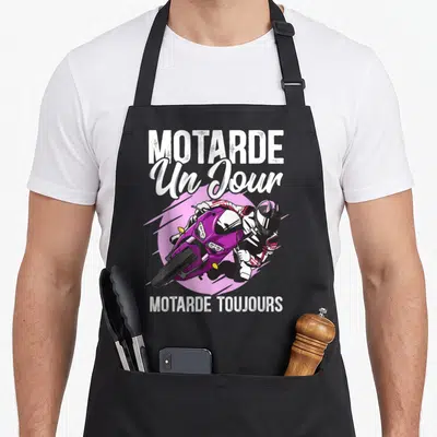Tablier de cuisine noir avec une motarde sur moto violette et le texte Motarde Un Jour Motarde Toujours en blanc.