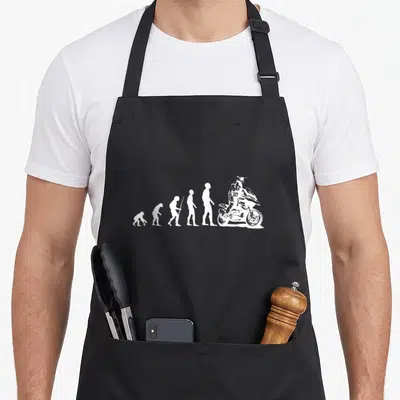 Tablier de cuisine noir avec illustration blanche montrant l'évolution de l'homme en motard sur enduro GS.