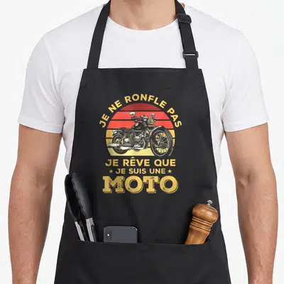Tablier de cuisine noir avec illustration vintage d'une moto noire et texte jaune Je ne ronfle pas je rêve que je suis une moto.