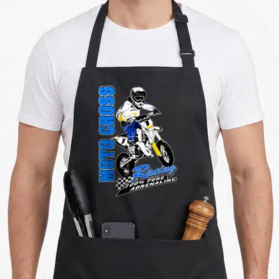 Tablier de cuisine noir avec illustration de pilote de motocross blanc et bleu sautant sur un circuit.