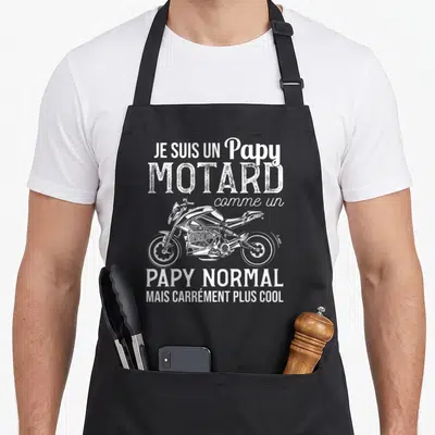 Tablier de cuisine noir avec illustration blanche de moto et texte Je suis un Papy Motard comme un papy normal mais carrément plus cool.
