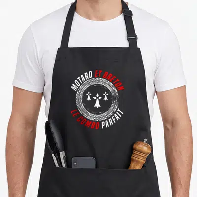 Tablier de cuisine noir avec motif circulaire motard breton et traces de pneu en blanc et rouge.