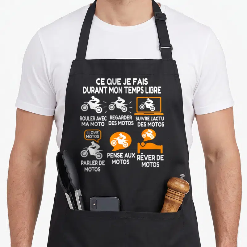 Tablier de cuisine noir avec illustrations blanches et oranges représentant des passionnés de motocyclettes et leurs loisirs quotidiens.