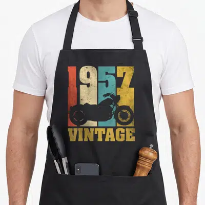 Tablier de cuisine noir avec motif vintage 1957 VINTAGE et silhouettes de motos colorées.