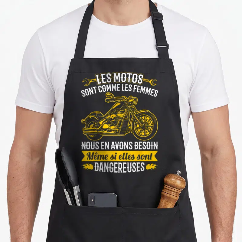 Tablier de cuisine noir avec illustration de chopper jaune et texte humoristique sur les motos et les femmes.